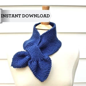 May include: A blue knitted scarf with a bow tie design. The scarf is displayed on a white mannequin. The text "INSTANT DOWNLOAD" is visible in the top left corner of the image.