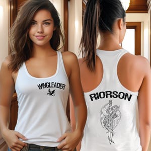 A woman wearing a white tank top with the text "WINGLEADER" and "RIORSON" printed on it.