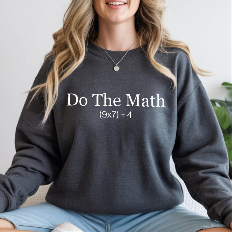 A woman wearing a gray sweatshirt with the text "Do The Math" printed on it.