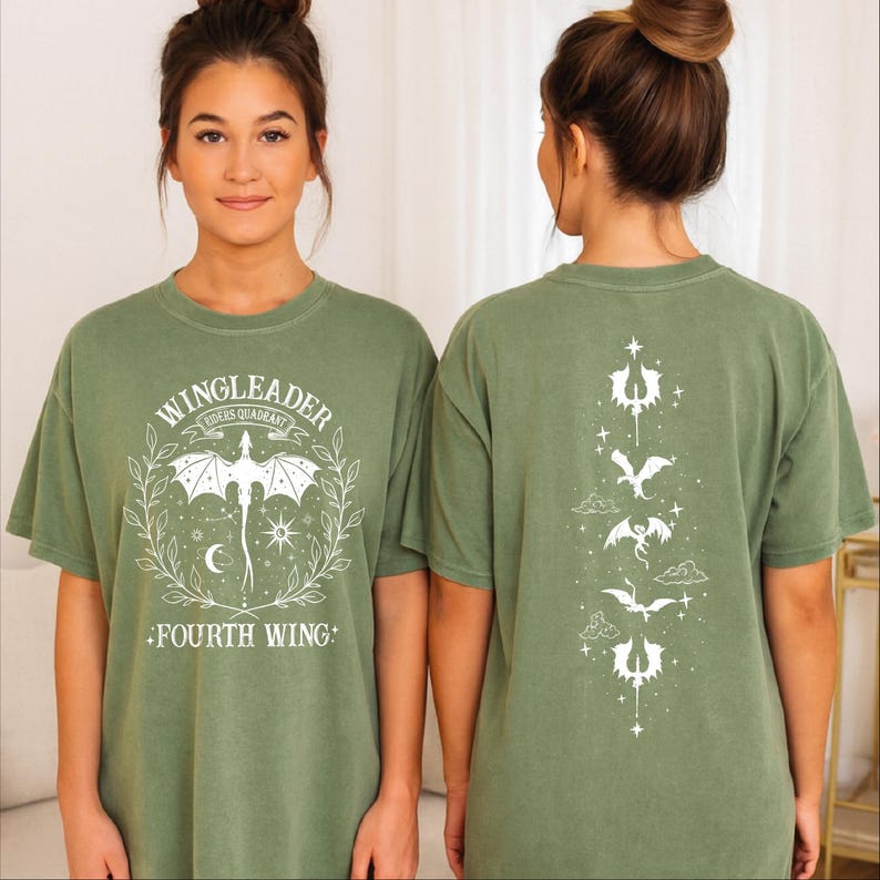 A woman wearing a green t-shirt with a graphic design on the front and a back featuring a series of winged creatures.