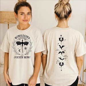 A woman wearing a white t-shirt with a graphic design on the front and a back featuring a similar design.