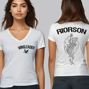 A woman wearing a white t-shirt with the text "WINGLEADER" printed on it, along with a graphic design of a sword and a dragon.