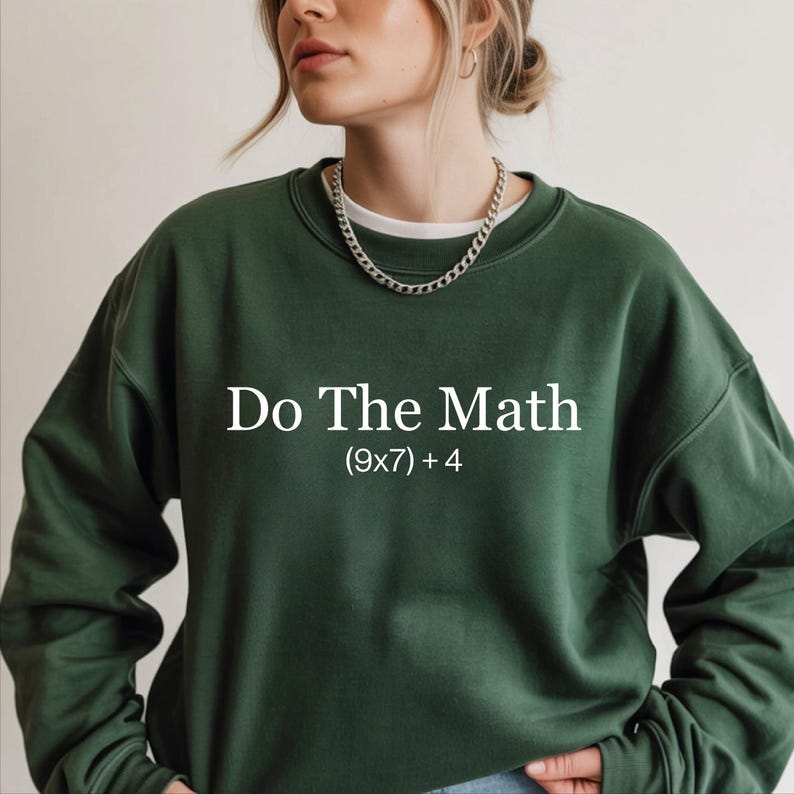 A woman wearing a green sweatshirt with the text "Do The Math" printed on it.