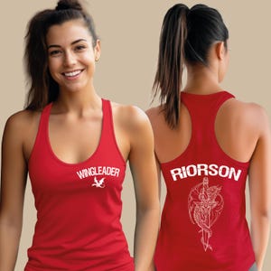 A smiling woman wearing a red tank top with the text "WINGLEADER" printed on it.