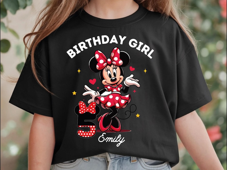 A young girl wearing a black t-shirt with a Minnie Mouse design and the text "Birthday Girl Emily" printed on it.