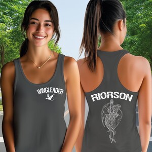 A woman wearing a grey tank top with the text "WINGLEADER" and "RIORSON" printed on it, smiling at the camera.