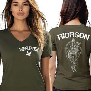 A woman wearing a green t-shirt with the text "WINGLEADER" printed on it, along with a graphic design of a dragon.