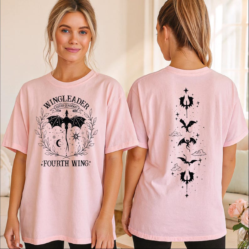 A woman wearing a pink t-shirt with a dragon design and text on it.