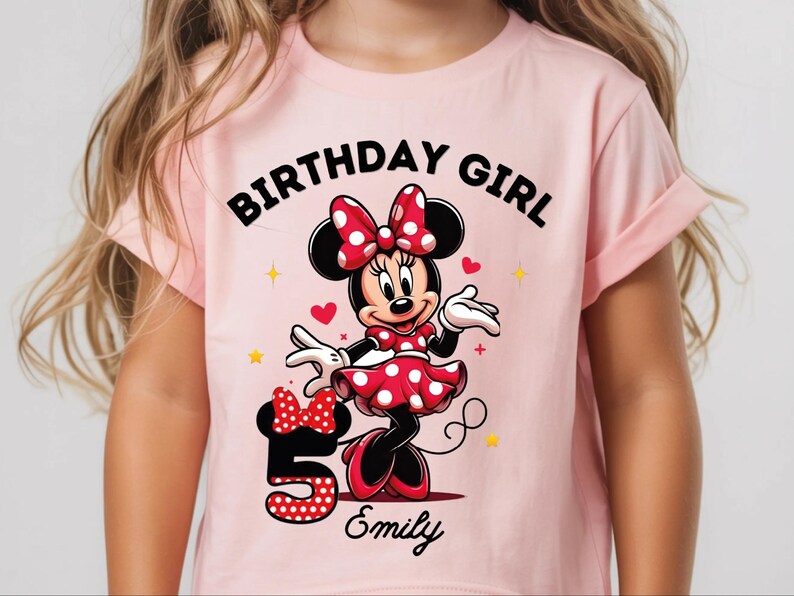 A young girl wearing a pink t-shirt with a Minnie Mouse design and the text "Birthday Girl Emily" printed on it.