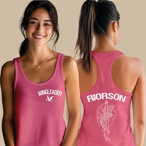 A woman wearing a pink tank top with the text "WINGLEADER" and a graphic design on the back.
