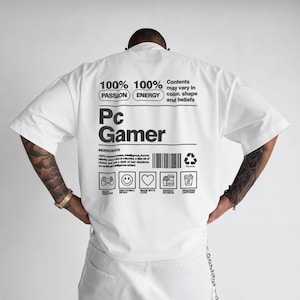 May include: White t-shirt with the text "Pc Gamer" and ingredient list printed on the back. The shirt features the words "Passion" and "Energy" above the text. The ingredient list includes icons of a game controller, a smiley face, a heart, a burger, and a coffee cup.