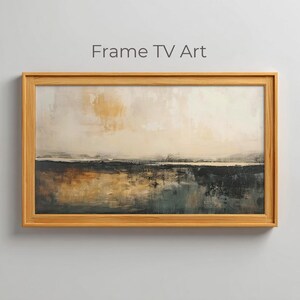 May include: A framed abstract landscape painting with a natural wood frame. The artwork features a blend of neutral colors, including beige, brown, and dark gray, creating a serene and modern aesthetic. The text "Frame TV Art" is at the top.