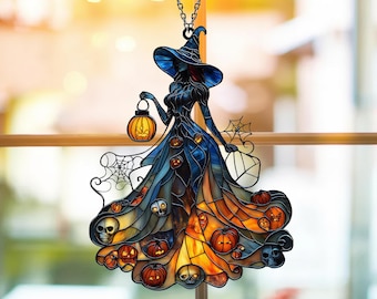May include: A stained glass Halloween decoration featuring a witch in a long dress, holding a lantern. The dress is adorned with pumpkins and skulls, with a spider web design. The witch's hat is blue, and the dress transitions from blue to orange.
