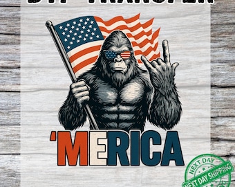 May include: DTF transfer featuring a muscular Bigfoot wearing sunglasses with an American flag design. The image includes the word "'MERICA" in red, white, and blue, and a waving flag. The design is on a white background.