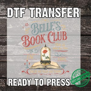 May include: DTF transfer design featuring the text "Belle's Book Club" in red and blue, with an illustration of a rose in a glass dome atop an open book. The words "Ready to Press" are also included.