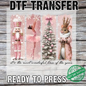 May include: DTF transfer featuring a pink and white Christmas theme. Includes a nutcracker, ballerina, Christmas tree, and mouse in a coat. Text reads "It's the most wonderful time of the year" and "Ready to press."