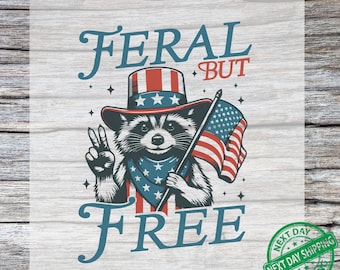 May include: A patriotic graphic featuring a raccoon wearing a red, white, and blue Uncle Sam hat and bandana, holding an American flag. The text reads "FERAL BUT FREE" and "READY TO PRESS".