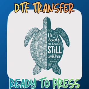 May include: A DTF transfer ready to press featuring a split-design sea turtle. The left side shows detailed shell textures, while the right side contains the text He leads me beside STILL waters Psalm 23:2 with starfish, coral, and shell icons.