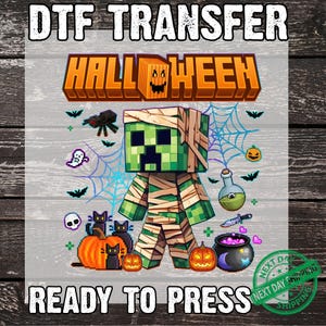 May include: A DTF transfer design with the text "DTF TRANSFER" and "READY TO PRESS". The design features a pixelated green mummy character with the word "HALLOWEEN" in orange. Includes Halloween-themed graphics like pumpkins, bats, and a cauldron.