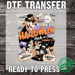 May include: DTF transfer featuring Mickey Mouse in a Halloween design. The design includes the text "Mickey's Halloween Trick-or-Treat Candy Co." and various cartoon characters. The words "Sugary Surprises" and "Sweet Scares" are also present.