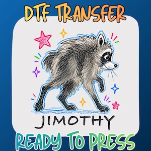 May include: A DTF transfer featuring a hand-drawn style illustration of a grey and black raccoon. The raccoon is surrounded by colorful stars and sparkles. The text reads DTF TRANSFER, JIMOTHY, and READY TO PRESS in a white rounded square.