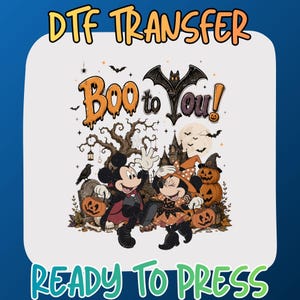 May include: A DTF transfer ready to press featuring a Halloween graphic with the text Boo to You. The design includes two cartoon mice in costumes, jack-o'-lanterns, a haunted house, a full moon, bats, and a bare tree on a light background.
