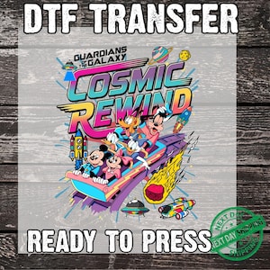 May include: A DTF transfer featuring the text Guardians of the Galaxy Cosmic Rewind. The graphic shows Mickey Mouse, Minnie Mouse, Donald Duck, Daisy Duck, Goofy, and Pluto riding a roller coaster in space with rockets, a planet, and a meteor.