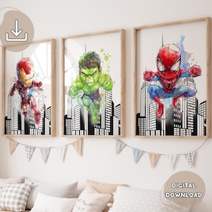 May include: Three digital prints of superhero characters in a watercolor style. The prints feature Iron Man, Hulk, and Spiderman in front of a cityscape background. The prints are framed in a light wood frame.
