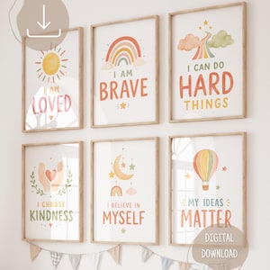 May include: Six framed wall art prints featuring pastel illustrations and motivational text. The prints display phrases including I AM LOVED, I AM BRAVE, I CAN DO HARD THINGS, I CHOOSE KINDNESS, I BELIEVE IN MYSELF, and MY IDEAS MATTER with rainbow, sun, and balloon motifs.