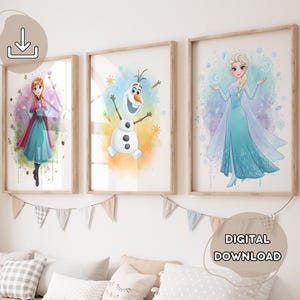 May include: Three framed watercolor prints featuring characters from a popular animated film. The prints depict a princess in a blue dress, a snowman, and another princess in a blue dress. The prints are in wooden frames and are labeled "DIGITAL DOWNLOAD".
