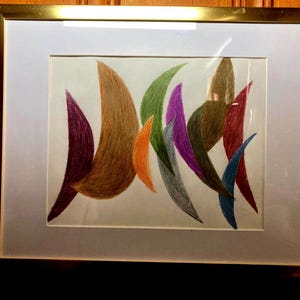 May include: Abstract artwork in a gold frame. The artwork features colorful, curved shapes in shades of brown, purple, orange, green, and blue. The shapes are arranged against a white background, creating a dynamic composition.