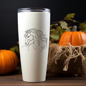May include: White stainless steel travel mug with a black line drawing of a horse's head on the side.