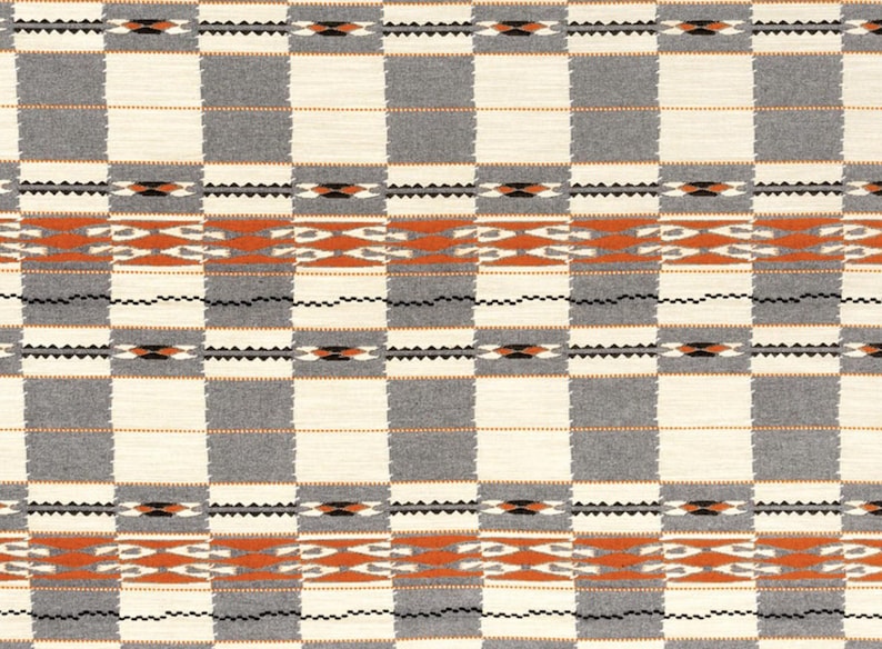 May include: A woven textile with a repeating geometric pattern. The design features alternating squares of gray and off-white, with bands of orange and black geometric shapes. The overall aesthetic is reminiscent of traditional Southwestern designs.