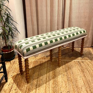 Christopher Farr Cloth bespoke upholstered bench in “Lost and Found” fabric by Kit Kemp with turned bobbin legs