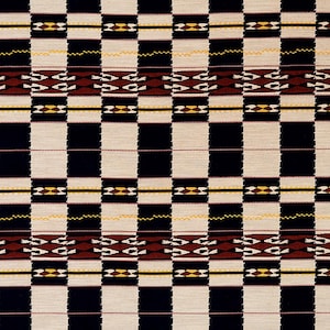 May include: A woven textile with a repeating pattern of large, alternating black and off-white squares. The design includes horizontal bands with geometric shapes in brown, yellow, and black, creating a bold, graphic look.