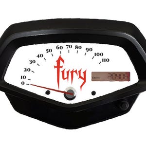 May include: A black motorcycle speedometer with a white face and red needle. The speedometer has a digital display showing "20406" and the word "Fury" in red lettering.