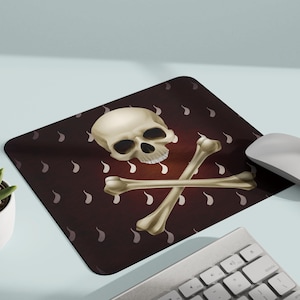 May include: A dark red mousepad with a white skull and crossbones design. The skull has a detailed, realistic look. The background is a repeating pattern of small white teardrop shapes.