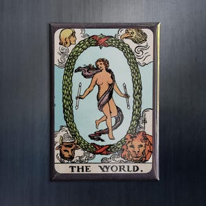 May include: A vintage tarot card with a colorful illustration of a woman standing in a wreath. The card is titled "THE WORLD."