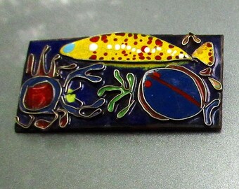 A Whimsical Ocean Critter Brooch:  cloisonne style enamel with silver wire on a copper back
