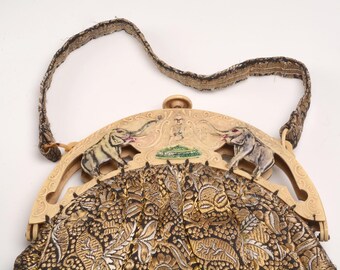 Celluloid Purse Frame with a design of elephants and the Hindu figure  of Lakshmi:  Gorgeous quilted fabric exterior