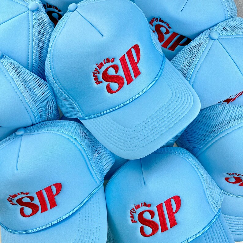 May include: A group of light blue trucker hats with a red embroidered logo that says "Party in the SIP".
