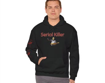 May include: Black hooded sweatshirt with the text "Serial Killer" in red. The sweatshirt features a graphic of a masked figure holding a knife. Red handprints are on the left sleeve. The sweatshirt has a front pocket and a drawstring hood.