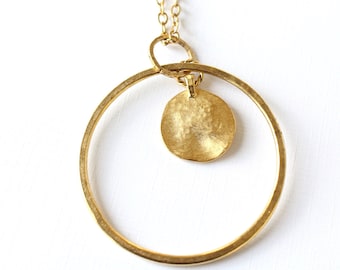 Gold hoop necklace with round gold charm