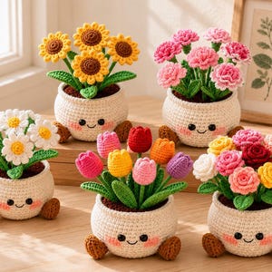 May include: Five crocheted potted plants featuring smiling cream-colored pots with small brown feet. The arrangements include yellow sunflowers, pink carnations, white daisies, multicolored tulips, and a variety of colorful roses with green leaves.