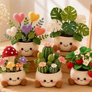 May include: Five crocheted potted plants with smiling faces on cream-colored pots. The collection includes heart-shaped flowers, a monstera plant, a mushroom cluster, a cactus with small flowers, and a strawberry plant with red berries and white blossoms.