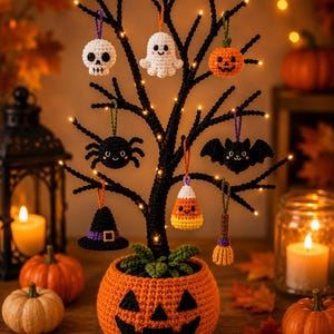 May include: A black decorative tree with small lights, potted in a crocheted orange jack-o'-lantern base. Hanging from the branches are crocheted ornaments: a white skull, a white ghost, an orange pumpkin, a black spider, a black bat, a black witch hat, a candy corn, and a brown broom.