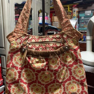 Fossil canvas and leather orange/yellow floral/geometric design shoulder bag