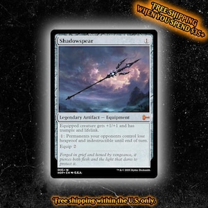 May include: A Magic: The Gathering trading card titled Shadowspear, a Legendary Artifact Equipment. The card art depicts a dark, ornate spear floating against a dramatic, cloudy purple and blue sky. The text details game mechanics.