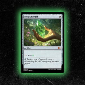 May include: A Mox Emerald card featuring a vibrant green gemstone held in a hand, set against a forest backdrop. The card is labeled "Artifact" and includes the text "Add ." and a description about nature's essence.