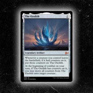 May include: A Magic: The Gathering card titled "The Ozolith." The card features a blue, crystalline structure against a landscape backdrop. The card is a Legendary Artifact. Text on the card describes its function in the game.